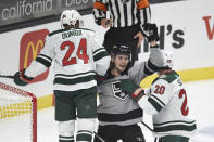 Los Angeles Kings right wing Adrian Kempe, center, celebrates after a goal by Gabriel Vilardi while Minnesota Wild defensemen Mathew Dumba, left, and Ryan Suter look on during the first period of an NHL hockey game in Los Angeles, Saturday, Jan. 16, 2021. (AP Photo/Kelvin Kuo)