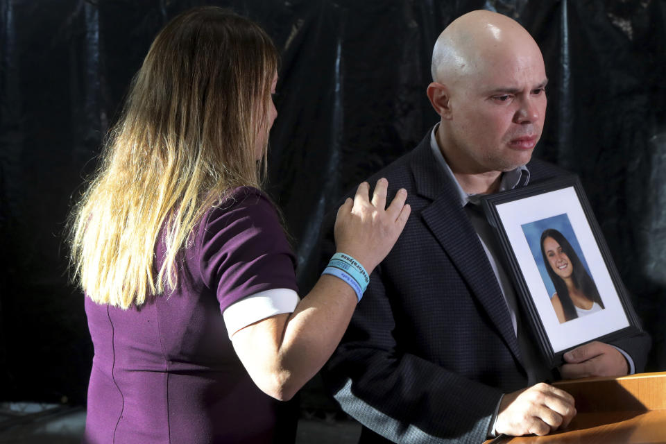 FILE - Lori Alhadeff, and her husband, Ilan Alhadeff, holding a photo of their daughter Alyssa, speak to the media after the sentencing hearing for Marjory Stoneman Douglas High School shooter Nikolas Cruz at the Broward County Courthouse in Fort Lauderdale, Fla., on Wednesday, Nov. 2, 2022. Alyssa was killed in the 2018 shooting. (Mike Stocker/South Florida Sun-Sentinel via AP, File)