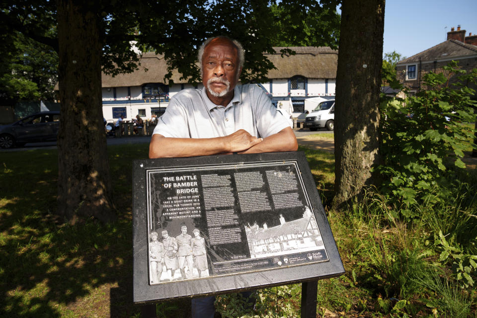 Clinton Smith, chair of Preston Black History Group is seen by the Ye Olde Hob Inn in Bamber Bridge near Preston, England, Thursday, June 22, 2023. What is now known as the Battle of Bamber Bridge erupted there on June 24, 1943 when white military police officers confronted black soldiers enjoying a night off in the local pub. (AP Photo/Jon Super)