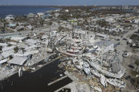 In this photo shot with a drone, shrimp boats lie grounded atop what was a mobile home park, following the passage of Hurricane Ian, on San Carlos Island in Fort Myers Beach, Fla., Friday, Oct. 7, 2022. (AP Photo/Rebecca Blackwell)