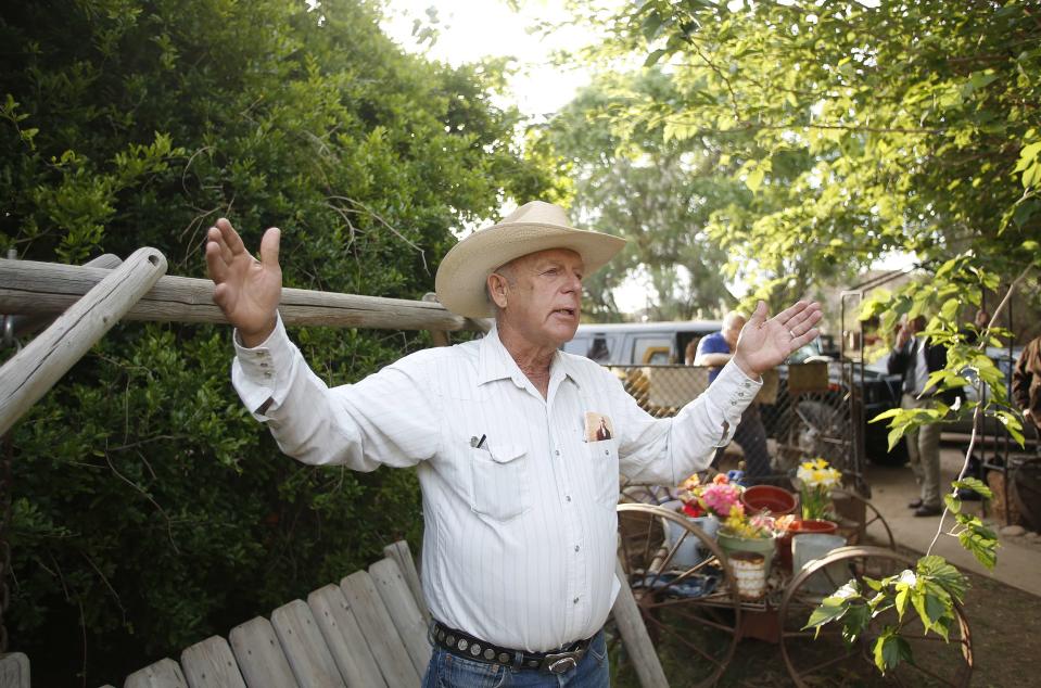 Rancher Cliven Bundy gestures at his home in Bunkerville, Nevada in this file photo taken April 12, 2014. A coalition of militia-men, cowboys on horseback, Western state lawmakers and others rallied to the side of Bundy in a tense stand-off with about a dozen agents from the Bureau of Land Management trying to round up his illegally grazing cattle on Saturday. (REUTERS/Jim Urquhart/Files)