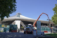 Workers and a cement pumping truck are shown, Tuesday, Sept. 1, 2020, as work continues on the Climate Pledge Arena in Seattle, the home of the Seattle Kraken NHL hockey team. Sometime in the late summer or early fall of 2021, the Kraken will open the new facility -- at a cost that will likely total $1 billion by the time it's done -- and become the NHL's 32nd franchise. (AP Photo/Ted S. Warren)