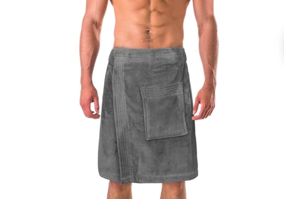 photo of torso of man in towel skirt