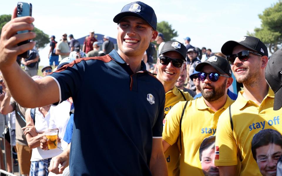 Ludvig Aberg takes a photograph with fans during a Ryder Cup practice round on Thursday