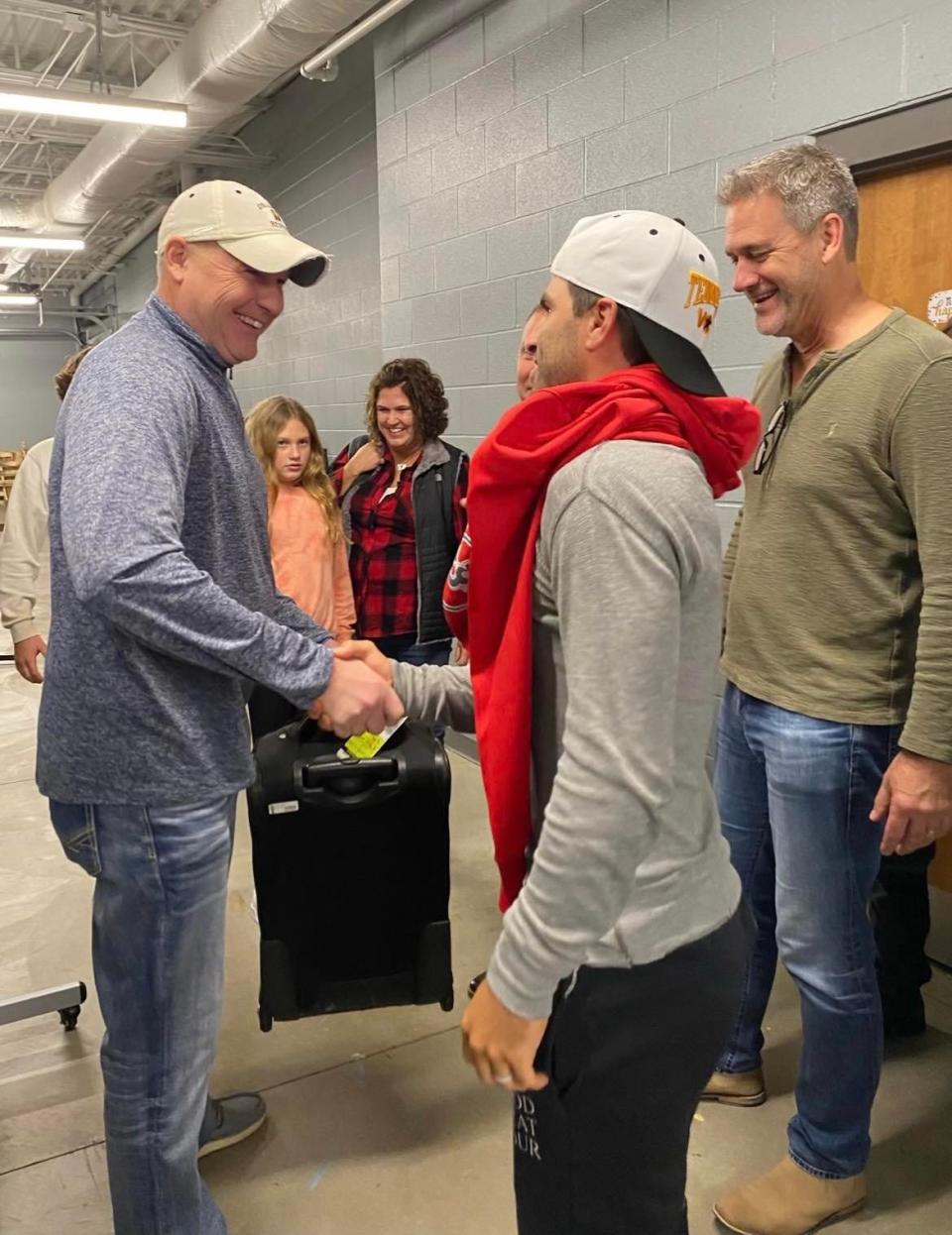 Country music artist Mitch Rossell, right, shakes hands with Bob Adams, of the Cleveland area prior to Rossell's concert at Canton South High School in November.