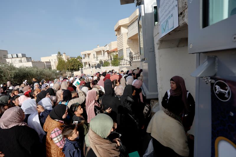 Palestinians make their way to attend the first Friday prayers of Ramadan through an Israeli checkpoint, in Bethlehem