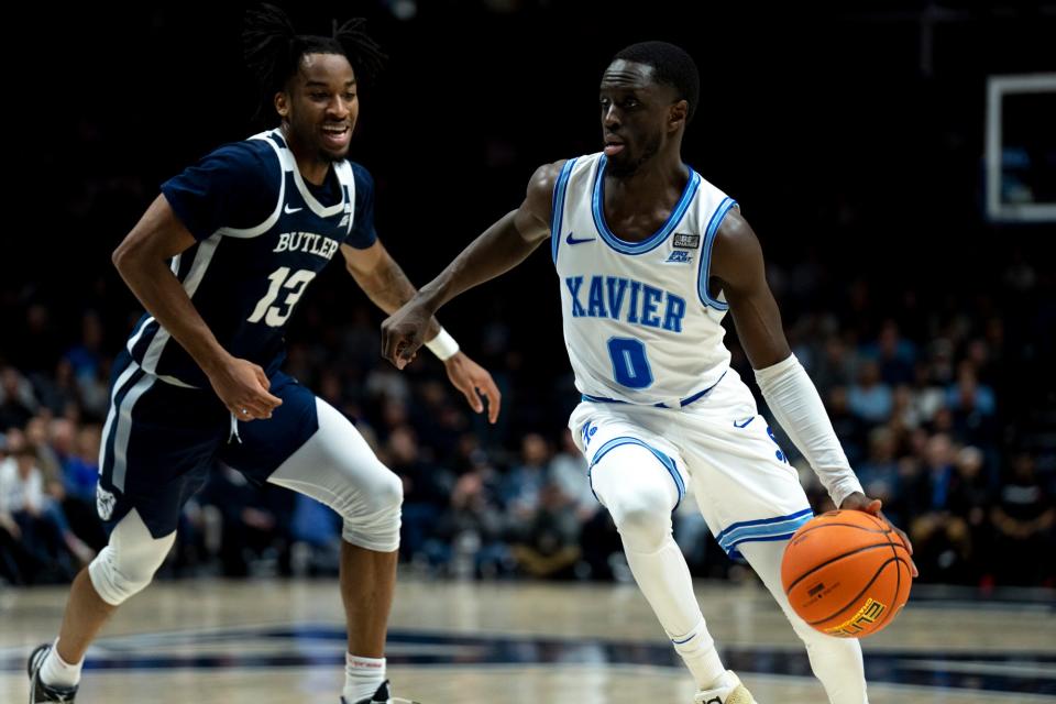 Xavier Musketeers guard Souley Boum drives past Butler Bulldogs guard Jayden Taylor