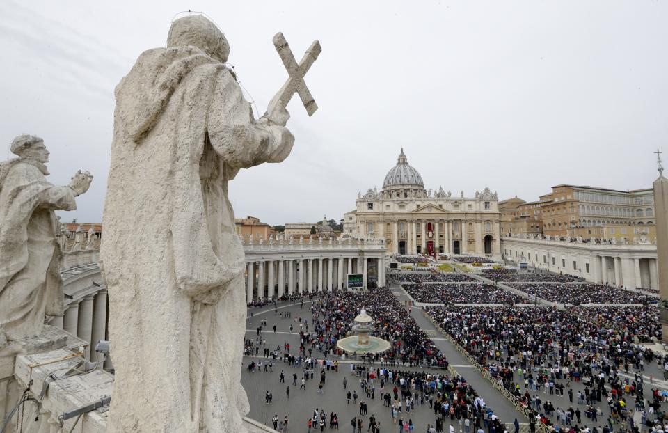 Faithful gather to follow Pope Francis celebrating Easter Mass in St. Peter's Square at the Vatican, Sunday, April 21, 2019. Pope Francis celebrates Easter Mass this year facing a fresh round of bloodshed targeting Christians in Sri Lanka. (AP Photo/Andrew Medichini)