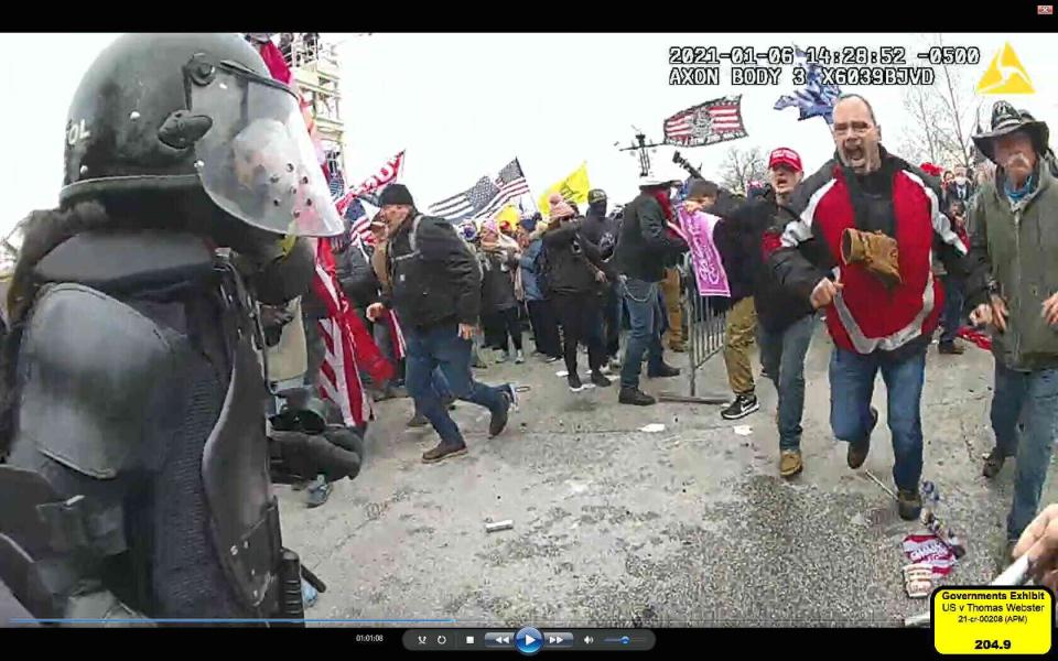 Thomas Webster, pictured here in a red jacket, from video on Jan. 6, 2021 at the U.S. Capitol riots.