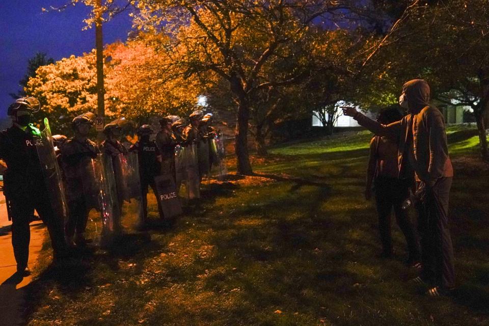 Protesters confront police and the National Guard Friday, Oct. 9, 2020, in Wauwatosa, Wis. On Wednesday, District Attorney John Chisholm refused to issue charges against Wauwatosa Police Officer Joseph Mensah for the Feb. 2 fatal shooting of 17-year-old Alvin Cole at Mayfair Mall. (AP Photo/Morry Gash)