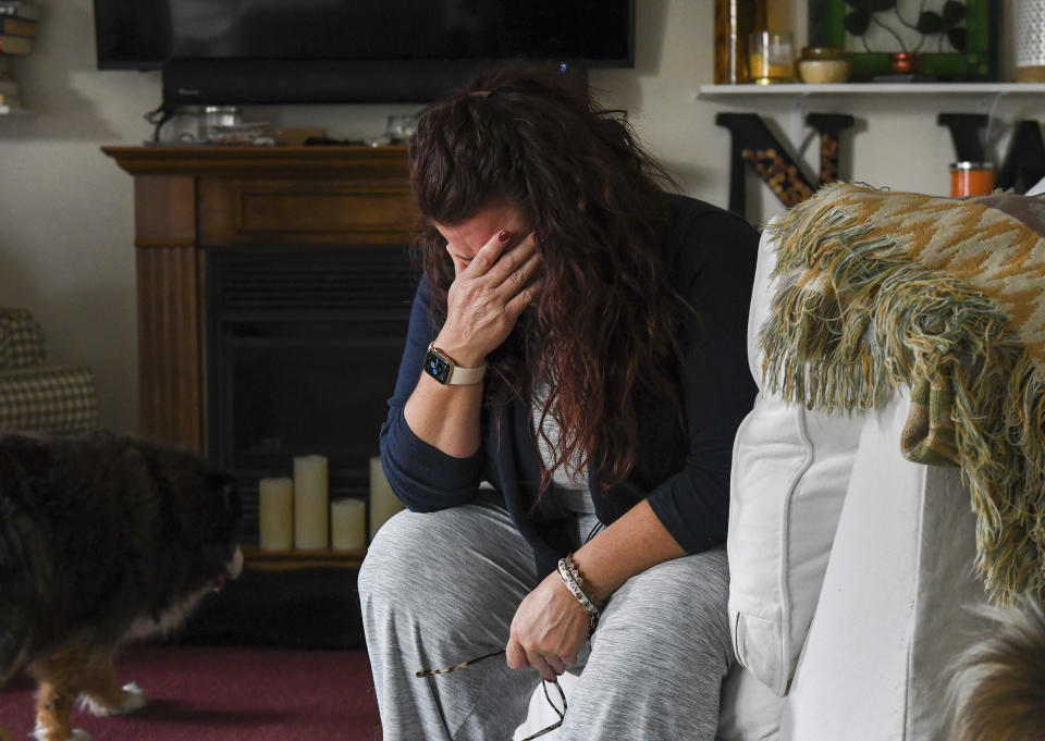 Natalie Walters, 53, becomes emotional while talking about her father at her home in Syracuse, N.Y., Tuesday, Sept. 21, 2021. Jack, who was staying at the Loretto Health and Rehabilitation nursing home in Syracuse, died of COVID-19 in December 2020. The facility's staffing has declined during the pandemic and Walters wonders if poor staffing played a role in her father's infection or death. Nationwide, one-third of U.S. nursing homes have fewer nurses and aides than before COVID-19 began ravaging their facilities, an Associated Press analysis of federal data finds. (AP Photo/Heather Ainsworth)