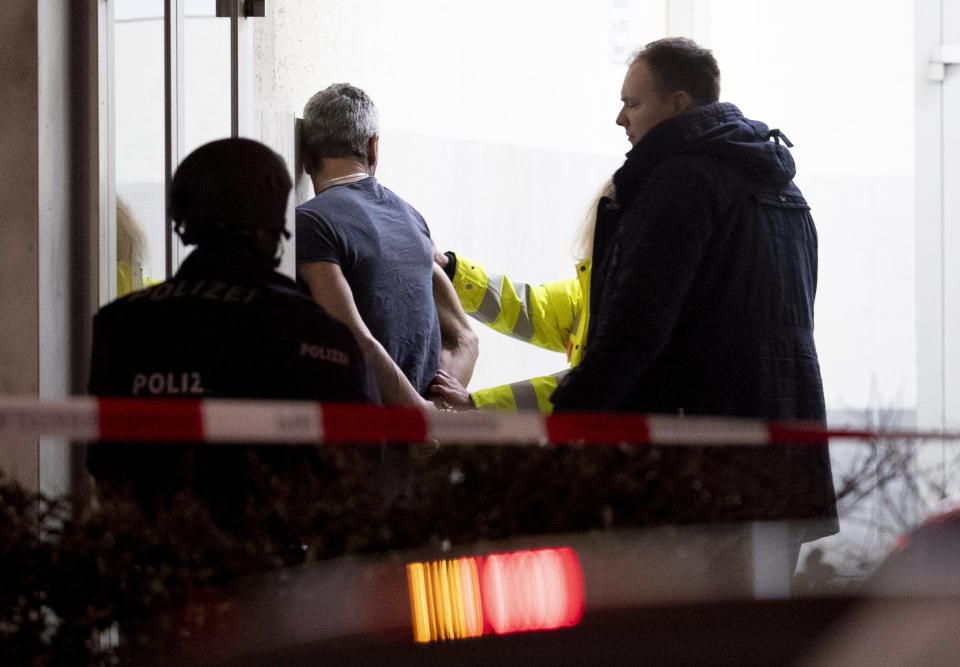 Police handcuff a man near the scene of a shooting in Hanau, Germany. Source: AP/Michael Probst