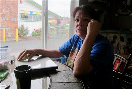 Jean Wood sits in the Butt's Tobacco store that she owns with her husband Larry in a strip mall south of Seattle, July 24, 2013. REUTERS/Andy Sullivan