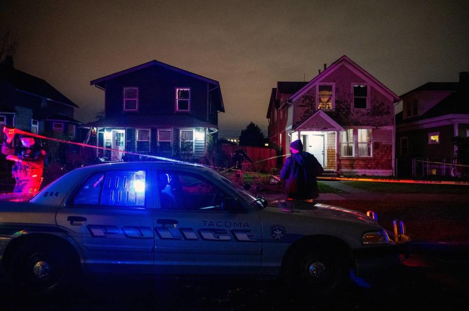 Officers from the Tacoma Police Department expand the crime scene where a man was shot in the 800 block of South Sheridan Avenue in Tacoma, Wash., on Monday, Jan. 17, 2022. According to a tweet from the Tacoma Police Department, a man was shot and found unresponsive at the scene when first responders arrived. The man was transported to a hospital where he later died from the injuries.