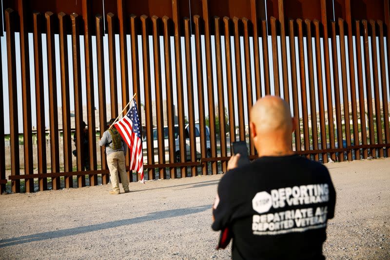 FILE PHOTO: Military veterans walk on the border between the U.S. and Mexico to request their return to the United States, in Sunland Park