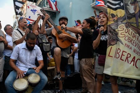 Members of theatre group Papel Machete perform during a protest calling for the resignation of Governor Ricardo Rossello in front of La Fortaleza in San Juan, Puerto Rico