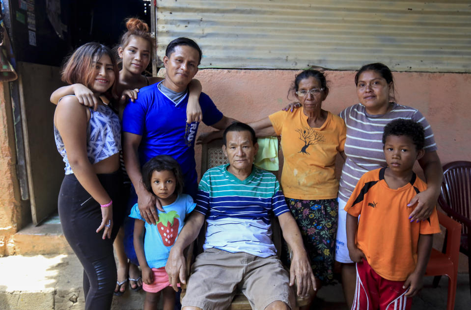 Franklin Perez, 29, wearing a solid blue jersey, poses with his family in their home, after he was released to house arrest, in Managua, Nicaragua, Friday, April 5, 2019. Perez is among the 50 people released Friday who had been jailed for protesting against President Daniel Ortega's government. However charges were not dropped against the demonstrators. Instead they were for the most part transferred to a form of house arrest, short of the unrestricted freedom that the opposition has demanded. (AP Photo/Alfredo Zuniga)