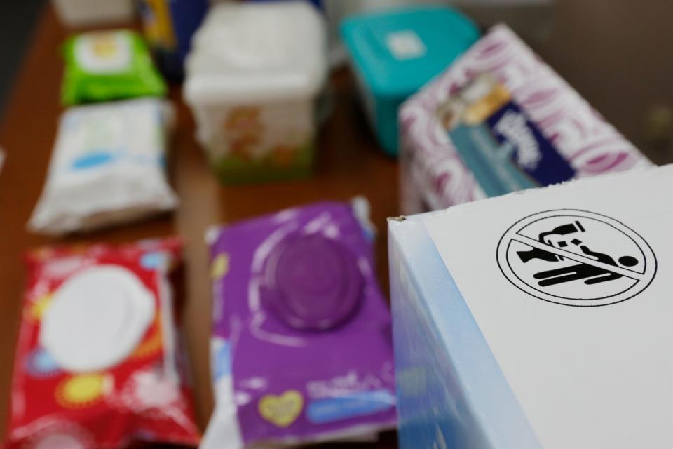 In this photograph taken Sept. 20, 2013, in Middlesex, N.J., the label that indicates wipes should not be flushed in a toilet is seen on a box next to baby wipes at the office of Rob Villee, executive director of the Plainfield Area Regional Sewer Authority in New Jersey. An industry trade group has come out with a universal stick-figure, do-not-flush symbol to put on packaging.