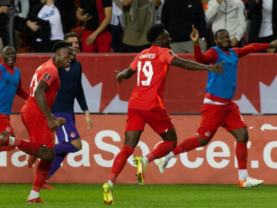 Alphonso Davies (19) and his Canadian teammates celebrate after his spectacular go-ahead goal in an eventual 4-1 win over Panama in October. (Chris Young/Canadian Press - image credit)