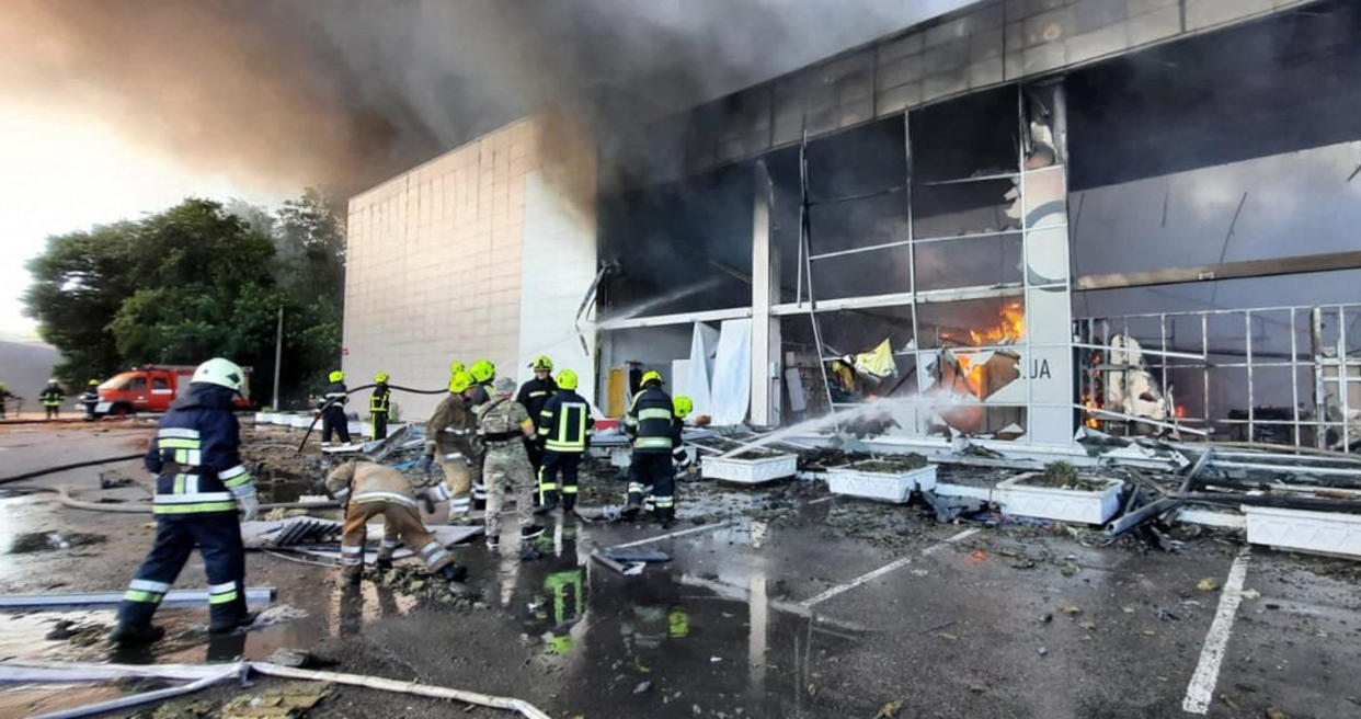 Firefighters put out the fire in a mall hit by a Russian missile strike (STR/Ukraine Emergency Ministry Press/AFP via Getty Images)