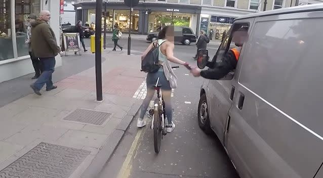 At one stage one of then in the van appears to reach out to touch the woman. Photo: Screenshot