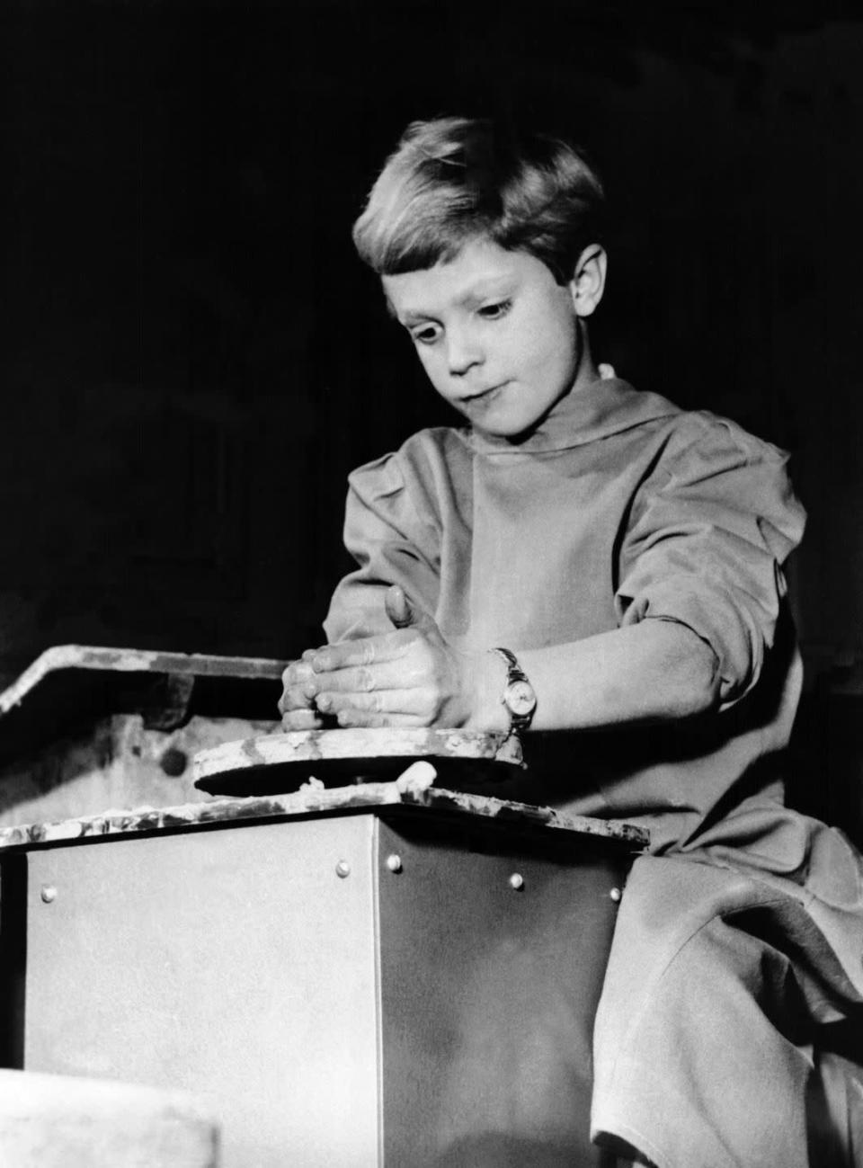 <p>Prince Carl at the pottery wheel as a child.</p>
