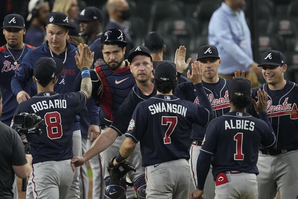 The Atlanta Braves celebrates after their win against the Houston Astros in Game 1 of baseball's World Series between the Houston Astros and the Atlanta Braves Tuesday, Oct. 26, 2021, in Houston. The Braves won 6-2. (AP Photo/Sue Ogrocki)