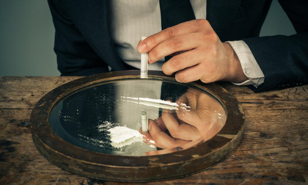 Businessman snorting cocaine