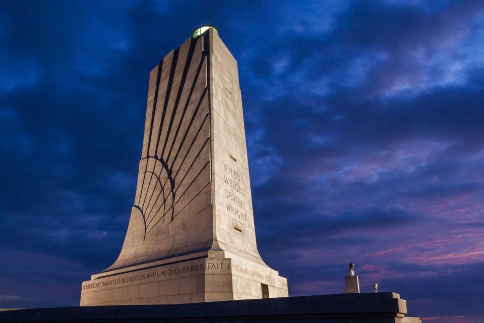 <p><strong>Wright Brothers National Memorial</strong></p><p>The Wright-Patterson Air Force Base located in Dayton, Ohio, is where Wilbur and Orville Wright worked on their aircraft and learned how to fly. The <a href="https://www.nps.gov/wrbr/index.htm" rel="nofollow noopener" target="_blank" data-ylk="slk:memorial;elm:context_link;itc:0;sec:content-canvas" class="link ">memorial</a>, which was first built in 1940, is a sight to be seen (and lit at night beautifully) and can be found on Wright Brothers Hill.</p>