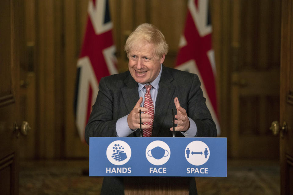 Britain's Prime Minister Boris Johnson gestures during a coronavirus briefing in Downing Street, London, Wednesday, Sept. 30, 2020. The number of new hospitalizations for COVID-19 and virus deaths in Britain are rising again, although both remain far below their springtime peak. (Jack Hill/Pool Photo via AP)