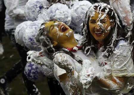 Students from St Andrews University are covered in foam as they take part in the traditional 'Raisin Weekend' in the Lower College Lawn, at St Andrews in Scotland, Britain October 17, 2016. REUTERS/Russell Cheyne