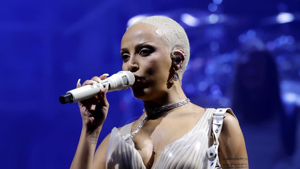 During a costume change in the middle of her set on the second weekend, Doja Cat wore a custom Asher Levine muscular bodysuit and furry over-the-knee boots. - Frazer Harrison/Getty Images for Coachella