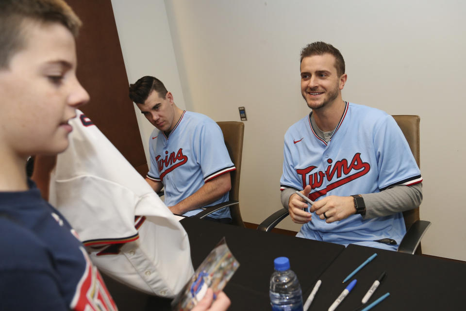 Minnesota Twins' Jake Odorizzi smiles after autographing a fan's jersey at the baseball team's TwinsFest, Friday, Jan. 24, 2020, in Minneapolis. (AP Photo/Stacy Bengs)