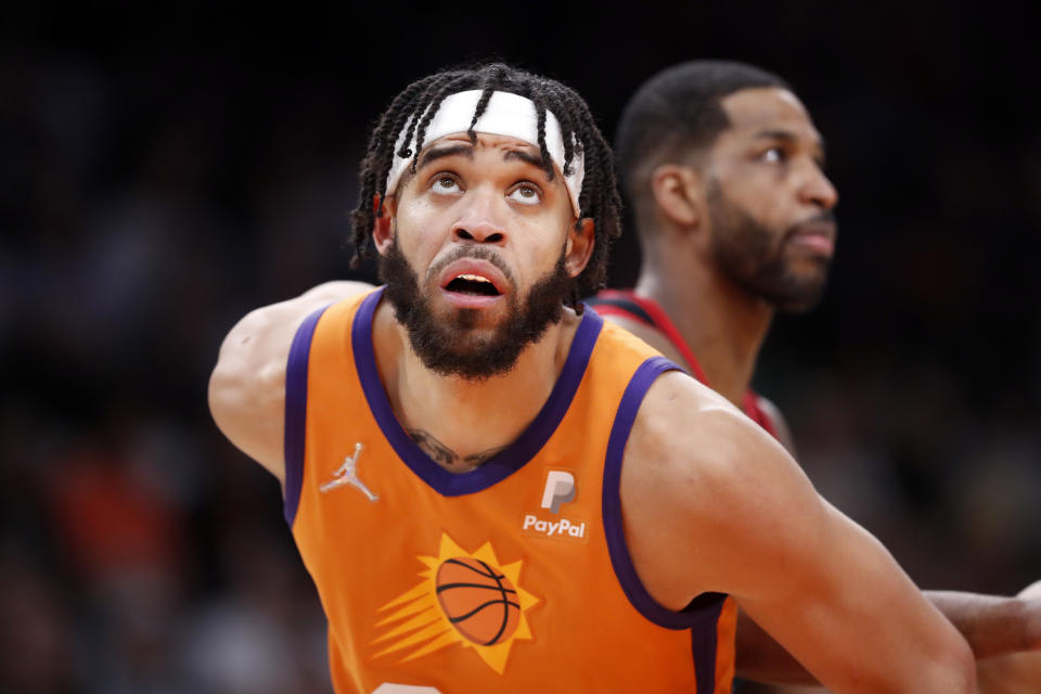 Pictured here, Suns star JaVale McGee gets ready to take a rebound for Phoenix in the NBA.