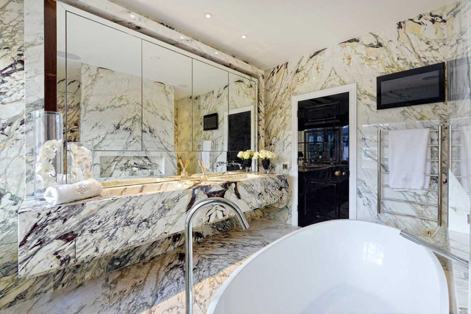 <p>The master-bathroom has wall-to-ceiling italian marble and a designer bathtub. Source: Rokstone </p>