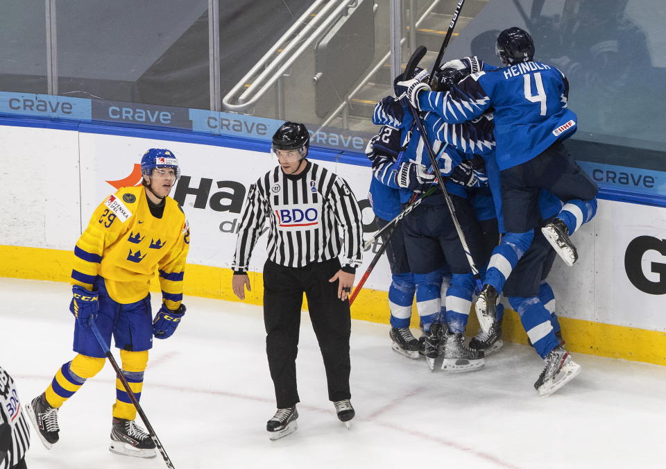 Sweden's Albin Sundsvik (29) looks on as Finland celebrates a goal during the third period of an IIHL World Junior Hockey Championship game, Saturday, Jan. 2, 2021 in Edmonton, Alberta. (Jason Franson/The Canadian Press via AP)