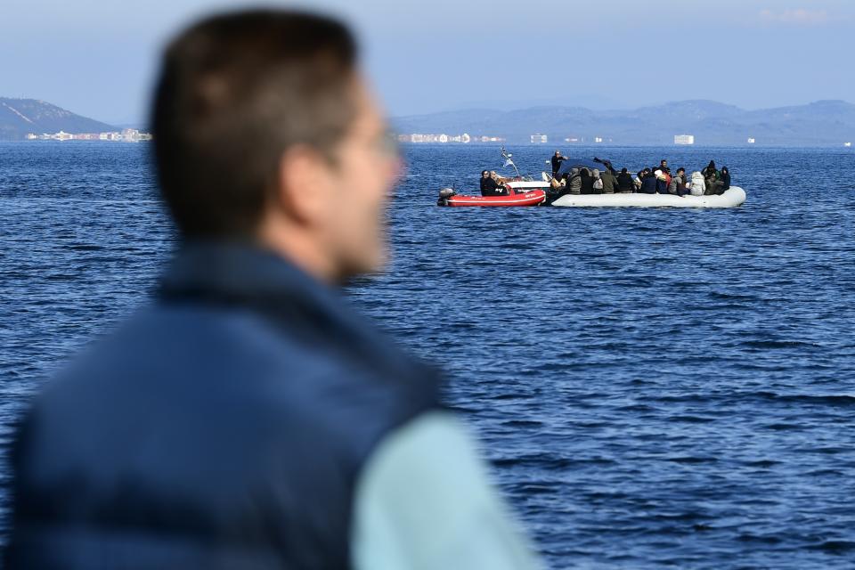Coast guard escort a dinghy as local residents prevent migrants from reaching the small port of Thermi, on the Greek island of Lesbos, after crossing the Aegean sea from Turkey, Sunday, March 1, 2020. Migrants and refugees were trying to enter Greece by land and by sea Sunday despite Greece making clear it would not allow anyone in, after Turkey officially declared its western borders open to those hoping to head into the European Union. (AP Photo)