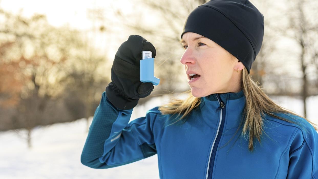  Female runner with asthma inhaler. 