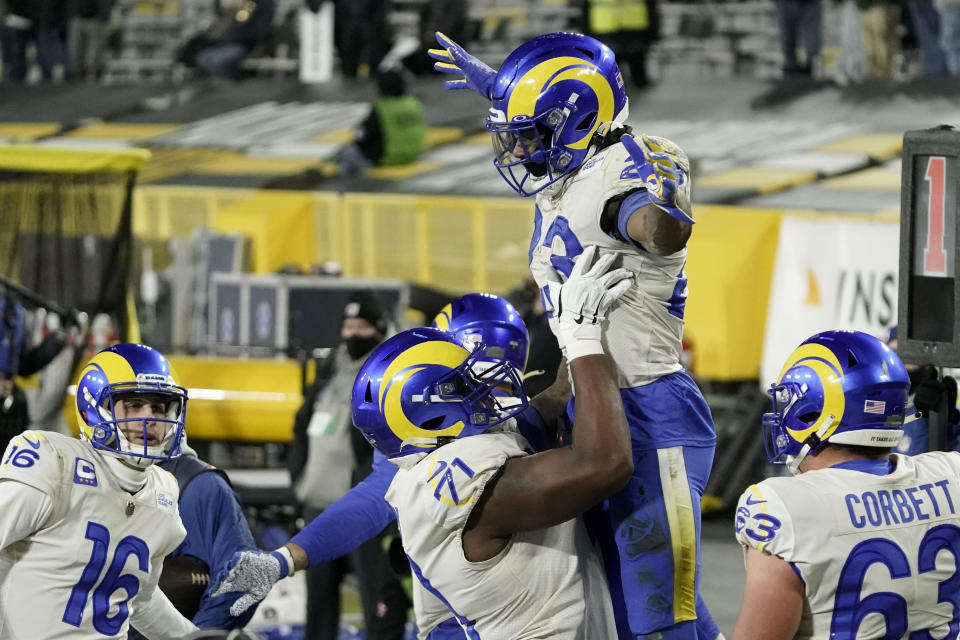 Los Angeles Rams' Cam Akers (23) is congratulated after scoring a two-point conversion against the Green Bay Packers during the second half of an NFL divisional playoff football game Saturday, Jan. 16, 2021, in Green Bay, Wis. (AP Photo/Morry Gash)