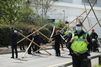 Emergency services dismantle the bamboo lock-ons used to block the road outside the Newsprinters printing works at Broxbourne, Hertfordshire. (Photo by Yui Mok/PA Images via Getty Images)
