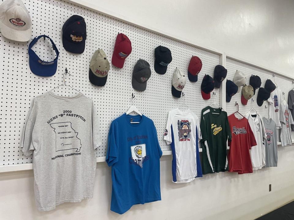 Softball jerseys and hats hanging around the Lodi Grape Festival hall during the 2023 Greater San Joaquin Softball District Hall of Fame event on Saturday, March 25, 2023.