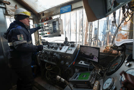 A drilling crew member works at an oil rig in the Yarakta Oil Field, owned by Irkutsk Oil Company (INK), in Irkutsk Region, Russia March 11, 2019. REUTERS/Vasily Fedosenko