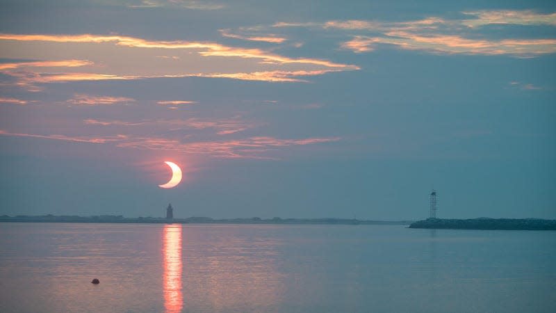 On Thursday, June 10, 2021, a partial solar eclipse was observed at sunrise behind the Delaware Breakwater Lighthouse at Lewes Beach, Delaware, while a “ring of fire” was visible in select parts of Greenland, Northern Russia, and Canada.