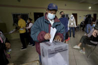 A man votes during general elections in Tegucigalpa, Honduras, Sunday, Nov. 28, 2021. (AP Photo/Moises Castillo)