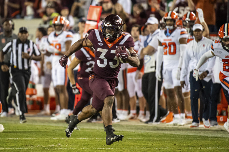 Syracuse's Bhayshul Tuten (33) runs the ball against Syracuse during the second half of an NCAA college football game Thursday, Oct. 26, 2023, in Blacksburg, Va. (AP Photo/Robert Simmons)