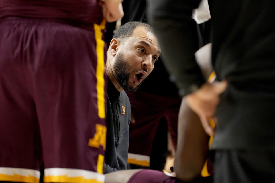 Minnesota head coach Ben Johnson talks to his players during a timeout in the second half of an NCAA college basketball game against Illinois Wednesday, Feb. 28, 2024, in Champaign, Ill. Illinois won 105-97. (AP Photo/Charles Rex Arbogast)