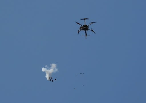 An Israeli drone drops tear gas canisters to disperse Palestinian protesters near the border east of Gaza City on May 15, 2018