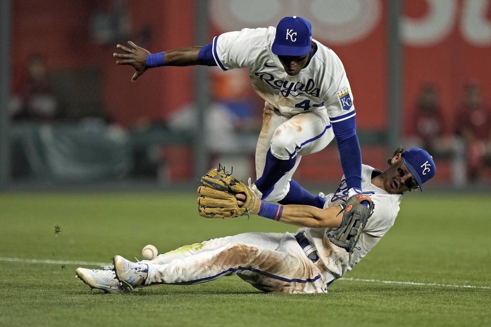 Kansas City Royals left fielder Dairon Blanco, top, and shortstop Bobby Witt Jr. collide trying to field a double hit by Cincinnati Reds' TJ Friedl during the seventh inning of a baseball game Monday, June 12, 2023, in Kansas City, Mo. (AP Photo/Charlie Riedel)