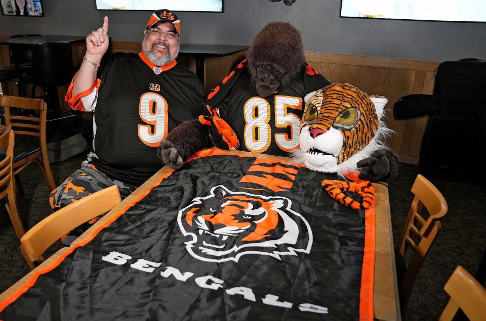 The Columbus Bengal Nation Facebook group organizer Tom Magin poses with Bongo, his stuffed animal gorilla, at The Pub in Gahanna, which has become a meeting place for Bengals fans on game days.