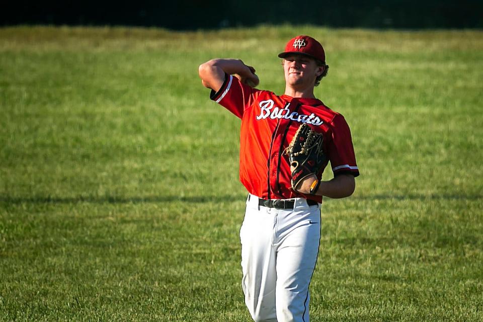 Western Dubuque's Brett Harris warms up in the outfield during a high school baseball game against Cedar Rapids Kennedy on May 30 in Farley.